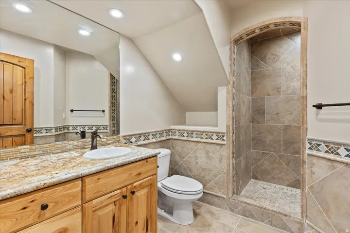 Recessed lighting with a full-width vanity mirror