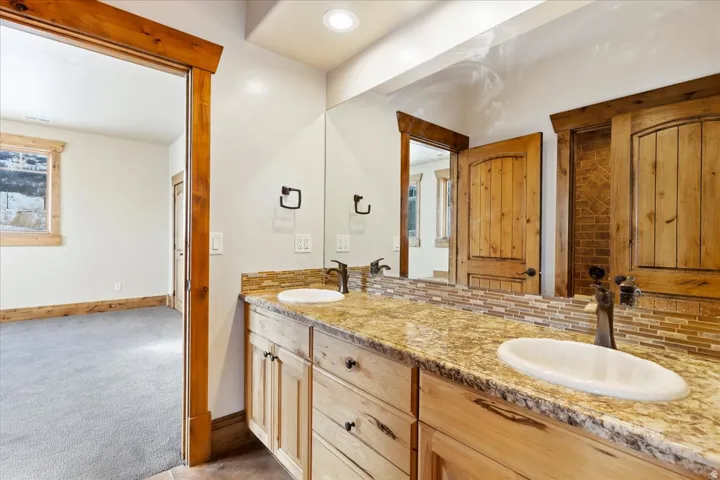 Double vanity with granite countertop and dual oval sinks