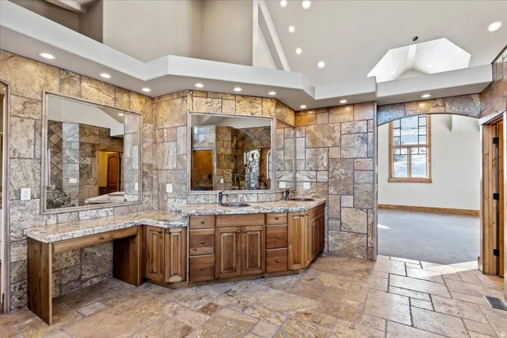 Expansive stone tile flooring and wall accents