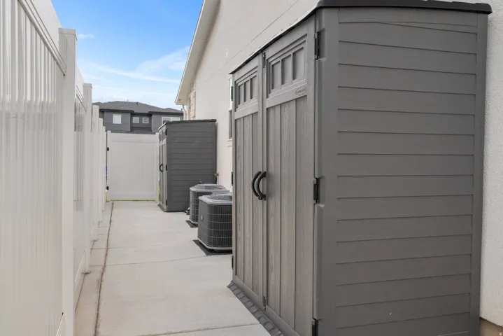 White privacy fencing with a concrete walkway