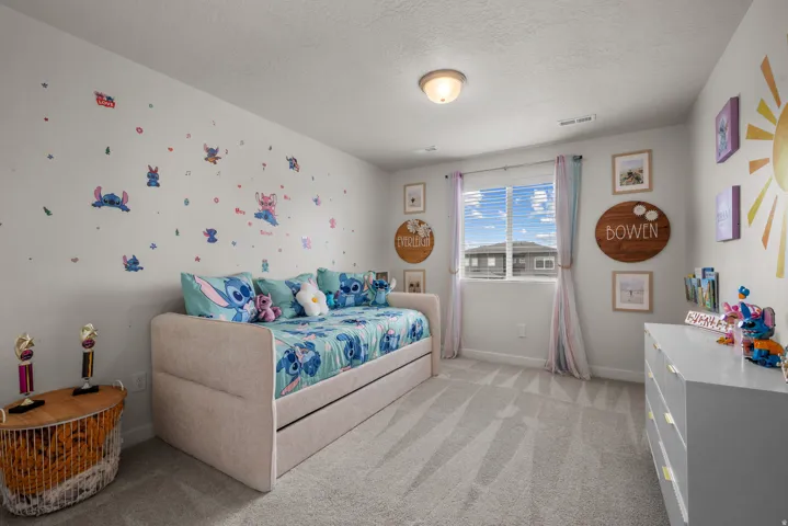 Recessed ceiling light, light gray wall paint, window with blinds, light gray carpeting, and a built-in closet