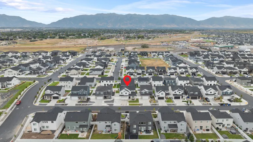 Residential neighborhood with uniform housing styles and mountain backdrop