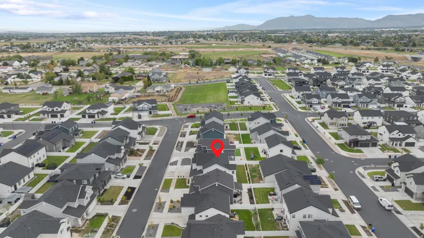 Residential neighborhood with uniform architecture, established road infrastructure, and natural landscaping