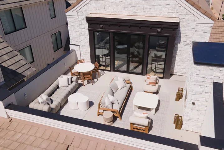 Expansive rooftop terrace with a light-colored paver surface