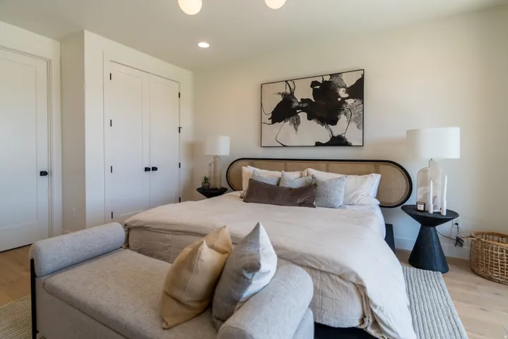 Light-toned wood-finish flooring, recessed lighting, and a built-in closet with double doors