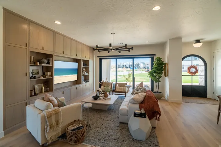 Integrated entertainment center with extensive built-in cabinetry, recessed lighting, and wood-finish flooring