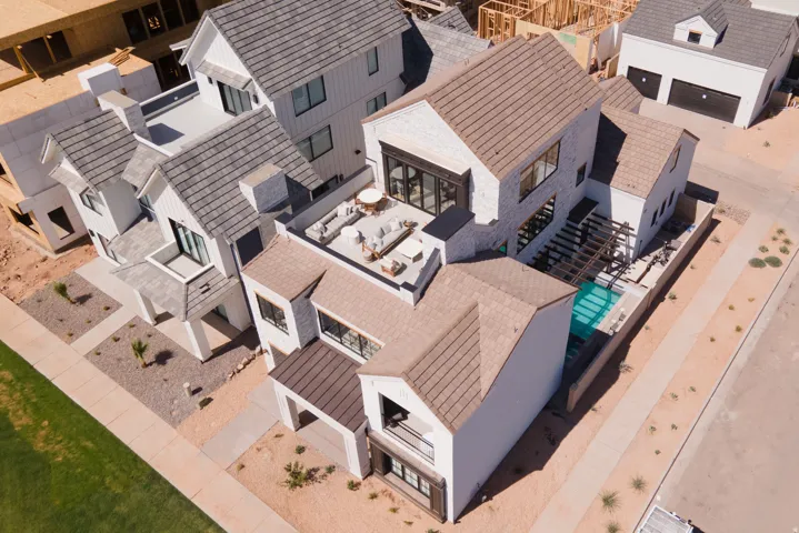 Contemporary residences featuring varied rooflines, private rooftop patios, a swimming pool, and covered outdoor structures