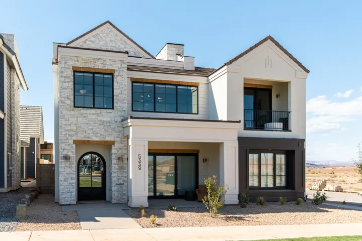 Stone veneer and stucco exterior with dark trim accents