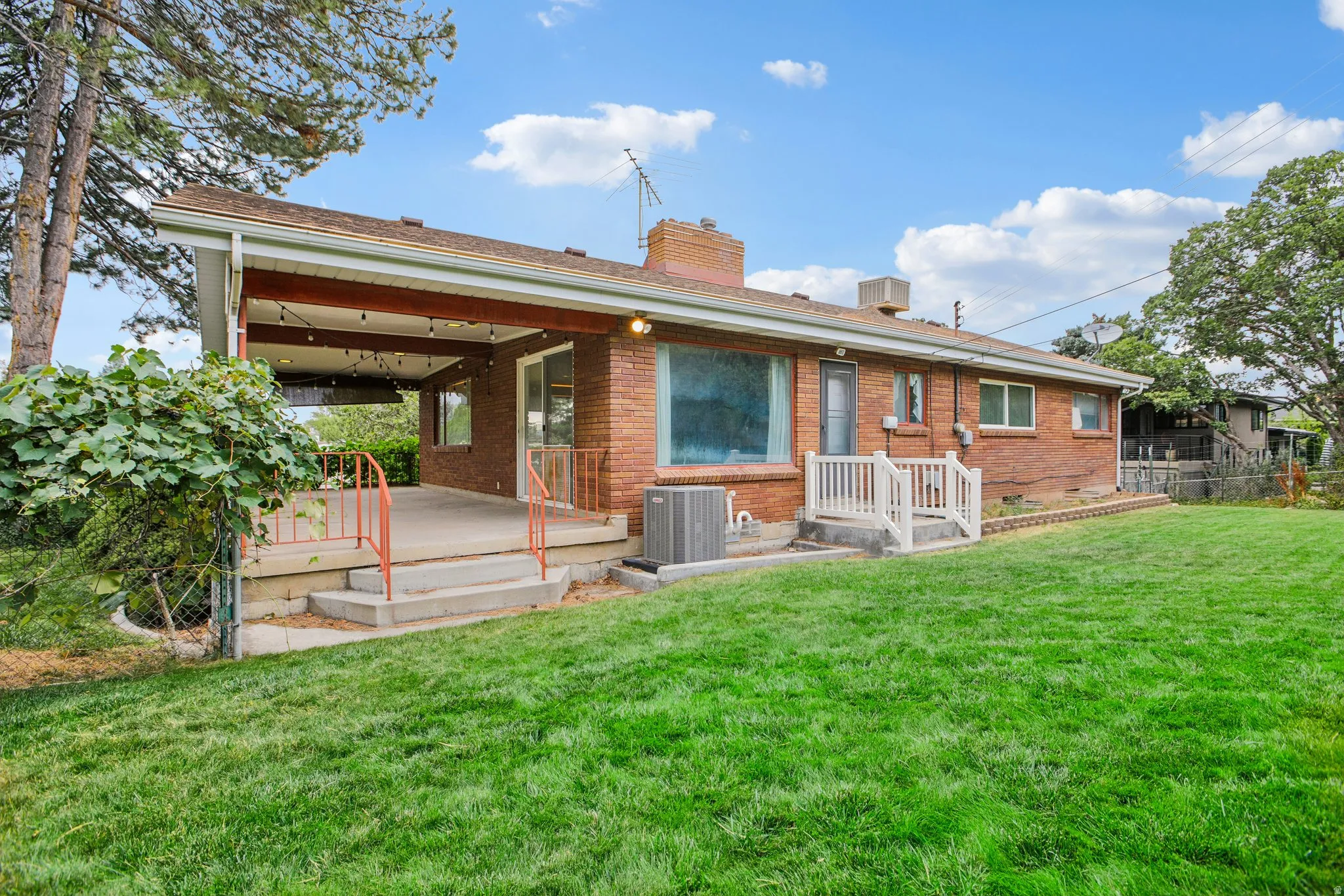 Brick exterior with covered concrete patio