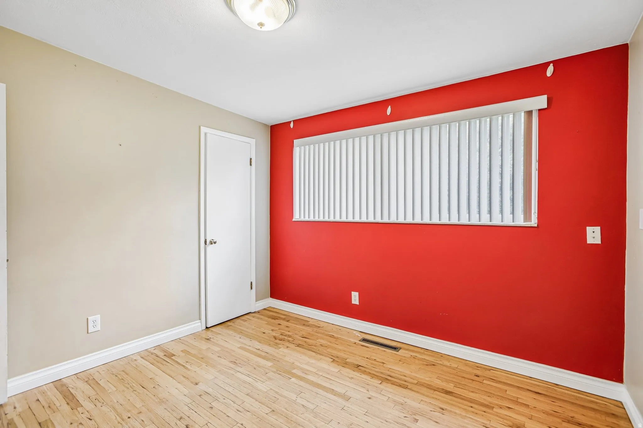 Natural wood-finish flooring with white trim