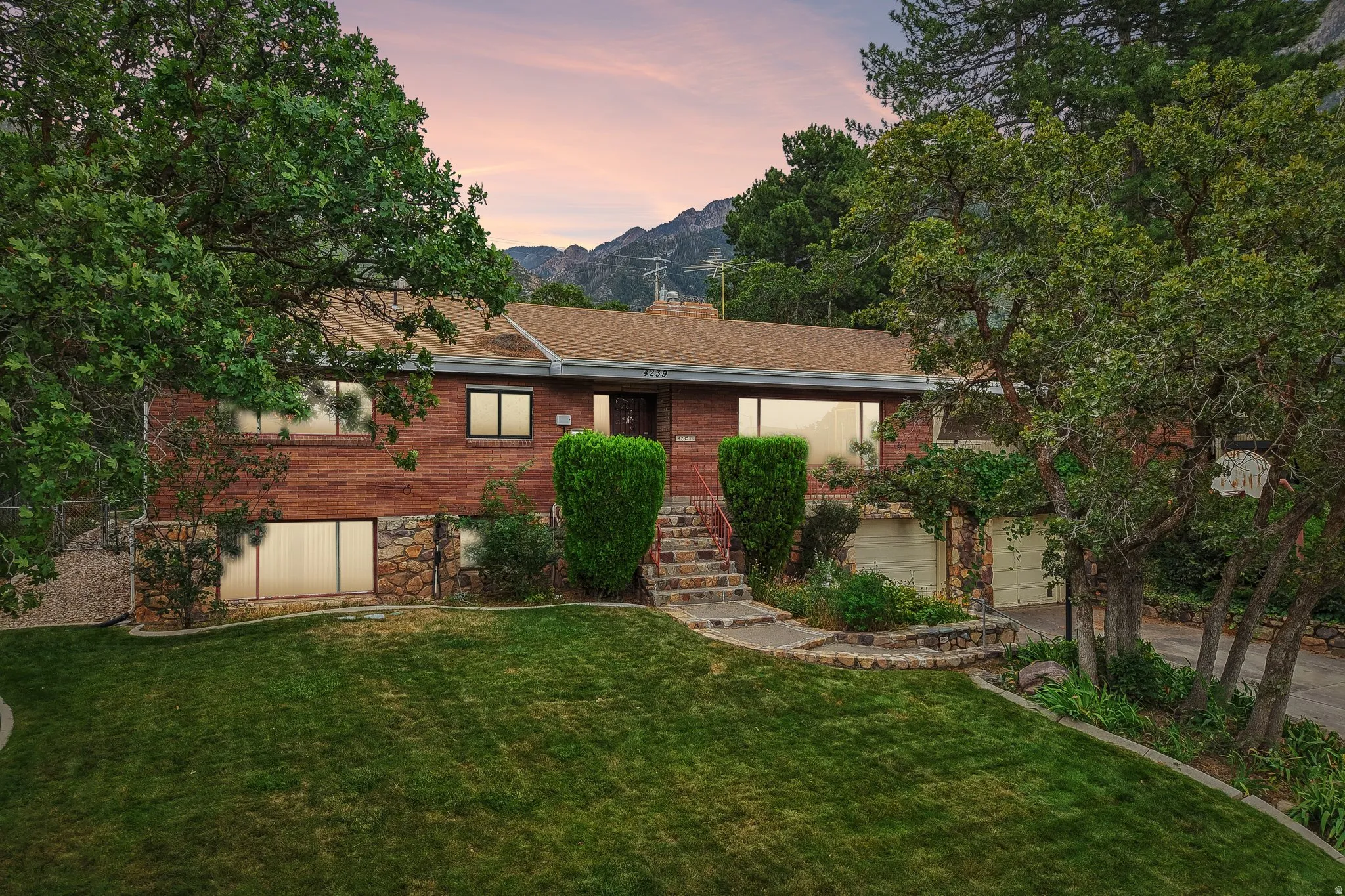 Red brick exterior with stone accents and a terraced stone walkway
