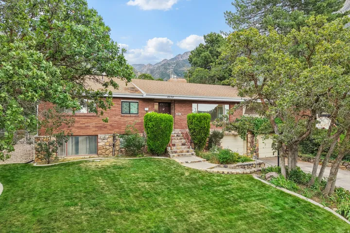 Brick exterior with stone accents and a sloped roof