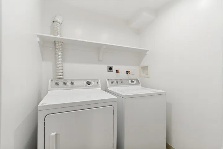 Laundry area with wall-mounted shelving