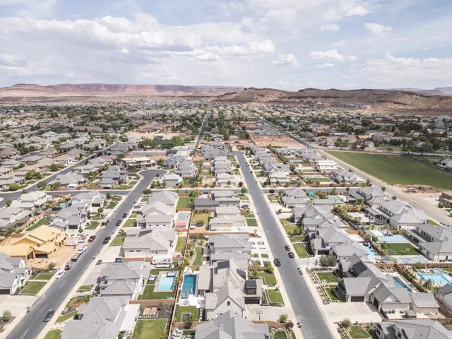 Residential neighborhood with mature landscaping and mountain backdrop