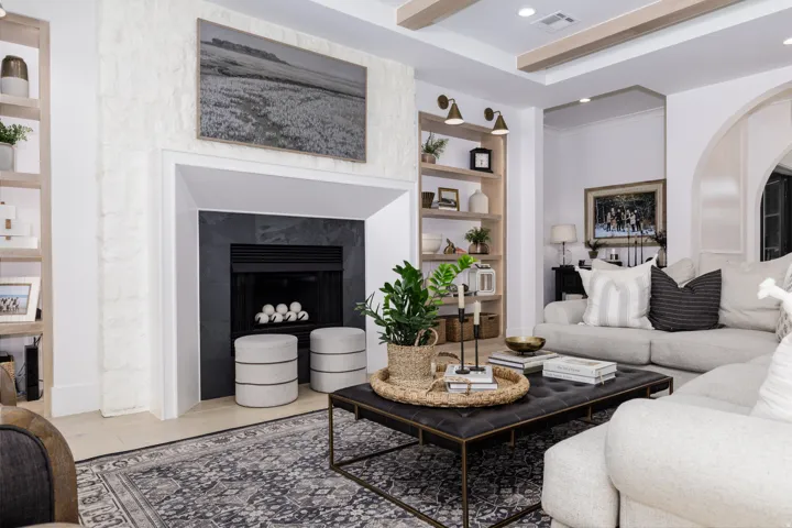 Textured fireplace surround with a dark stone hearth and firebox