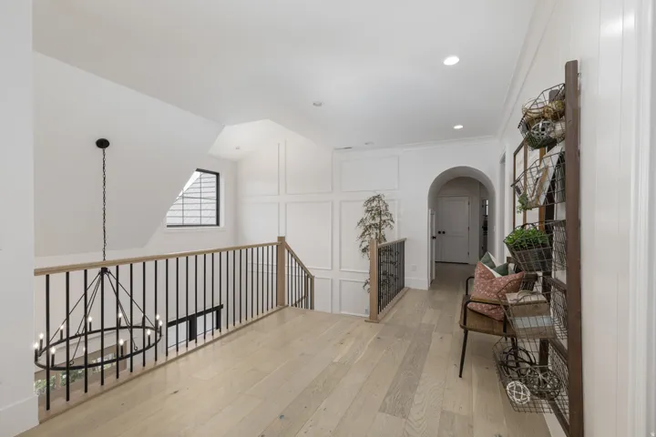 Light wood-finish flooring with white walls