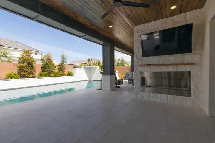 Covered patio with a wood-plank ceiling and recessed lighting