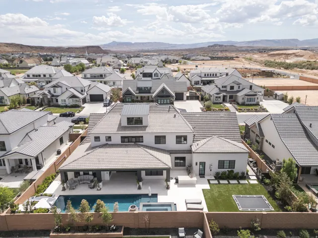Contemporary exterior featuring a tile roof, expansive patio, swimming pool, and integrated spa