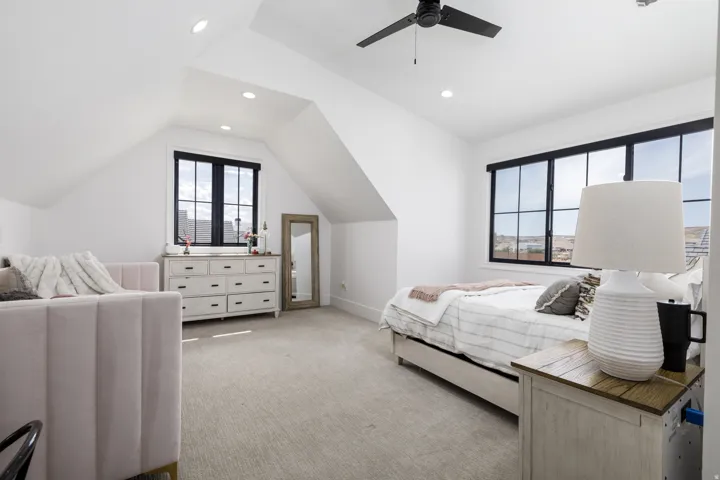 Recessed lighting, sloped ceilings, and a ceiling fan with light fixture