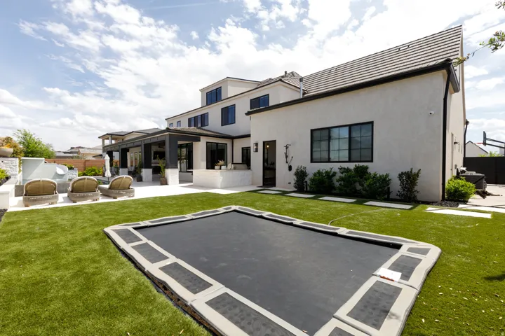 Expansive artificial turf lawn with an in-ground trampoline