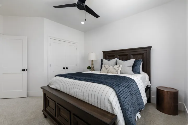 White interior doors with matte black hardware, recessed lighting, and a ceiling fan