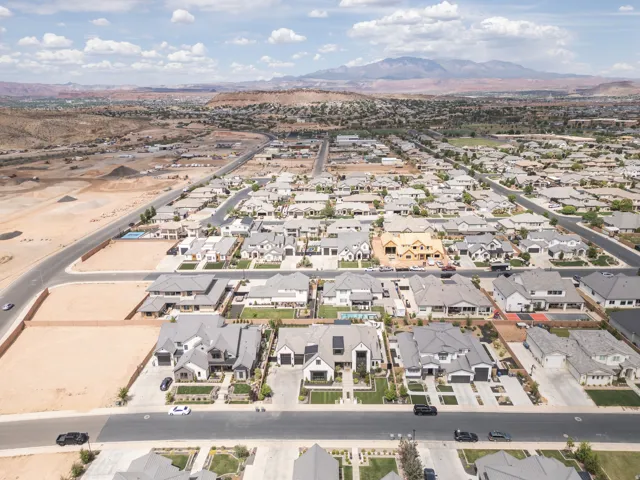 Expansive neighborhood showcasing diverse architectural styles, mature landscaping, and mountain backdrop