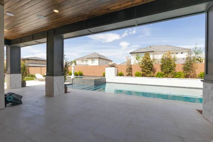 Covered patio with recessed lighting, wood-finish ceiling, stone-clad pillars, and tiled flooring