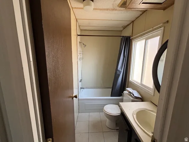 Bathroom with a built-in vanity, single-basin sink, and overhead light fixture