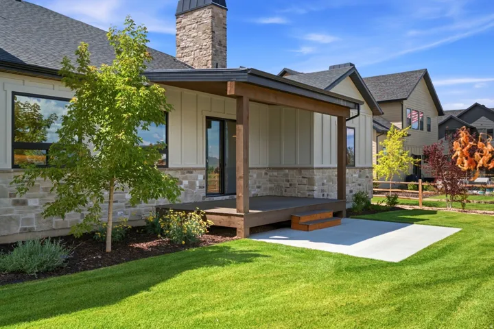 Covered patio with wood decking, direct yard access, and a concrete pad