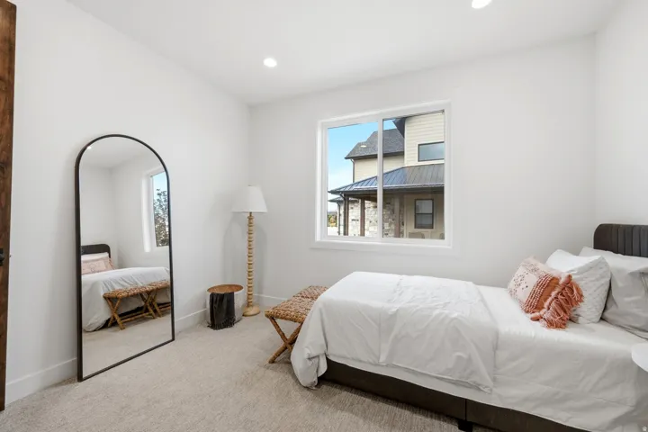 Recessed ceiling lighting, a window with exterior views, and neutral wall tones