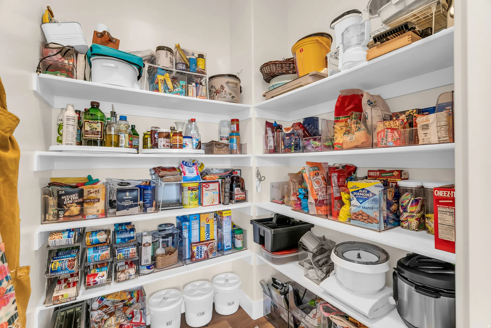 Built-in pantry shelving with white shelves and neutral wall tones