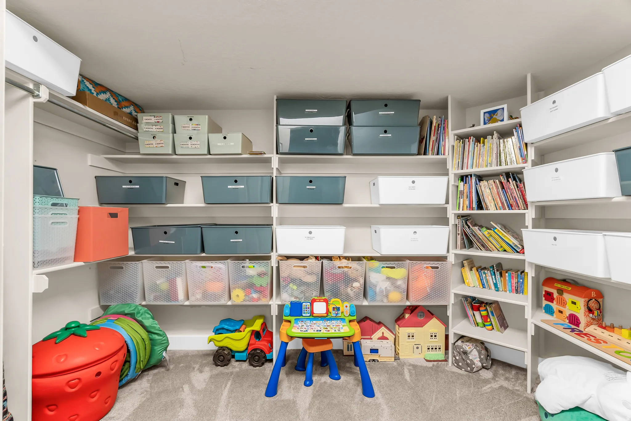 Built-in shelving with adjustable white shelves and integrated storage