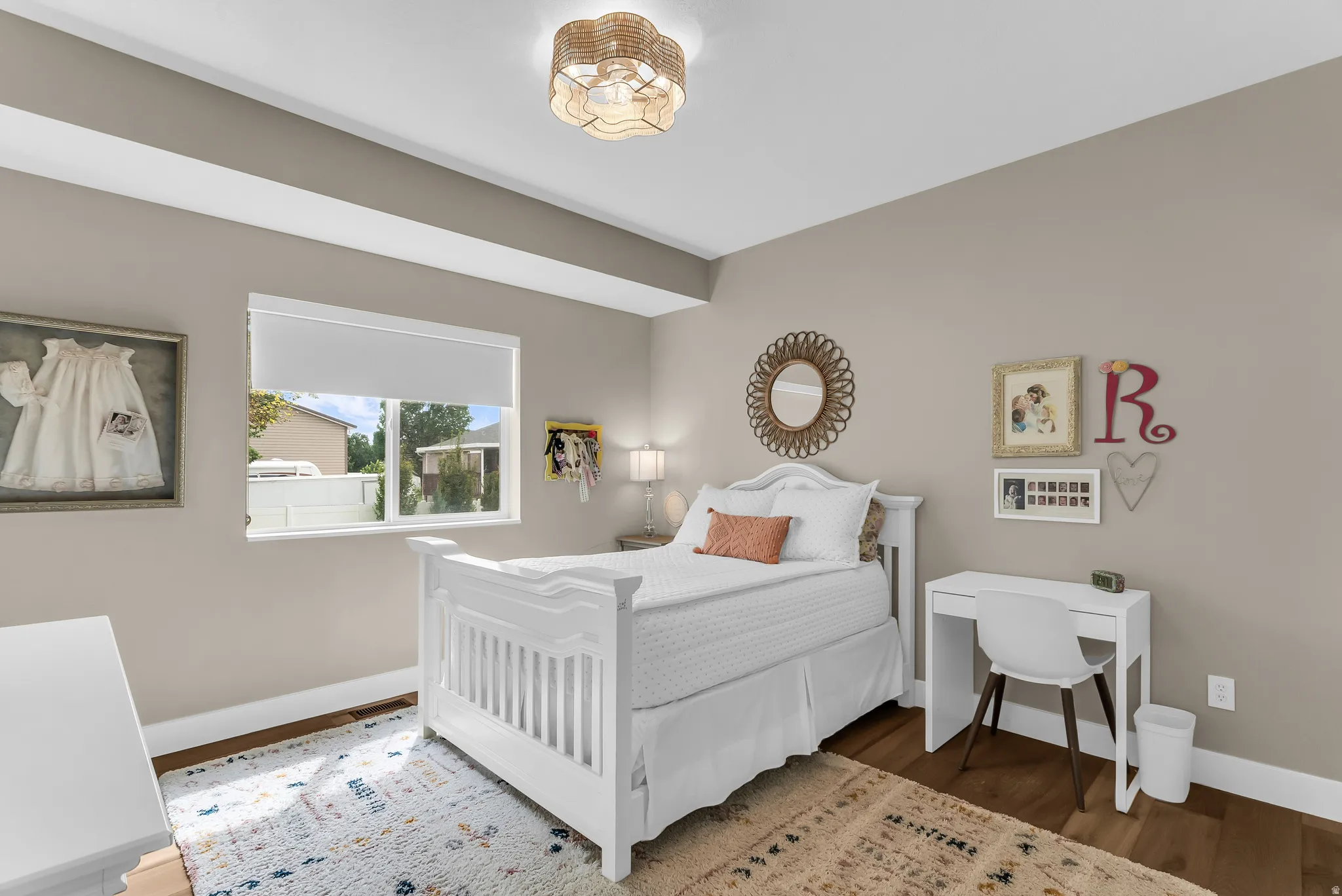 Recessed ceiling, wood-finish flooring, and a single window with roller shade