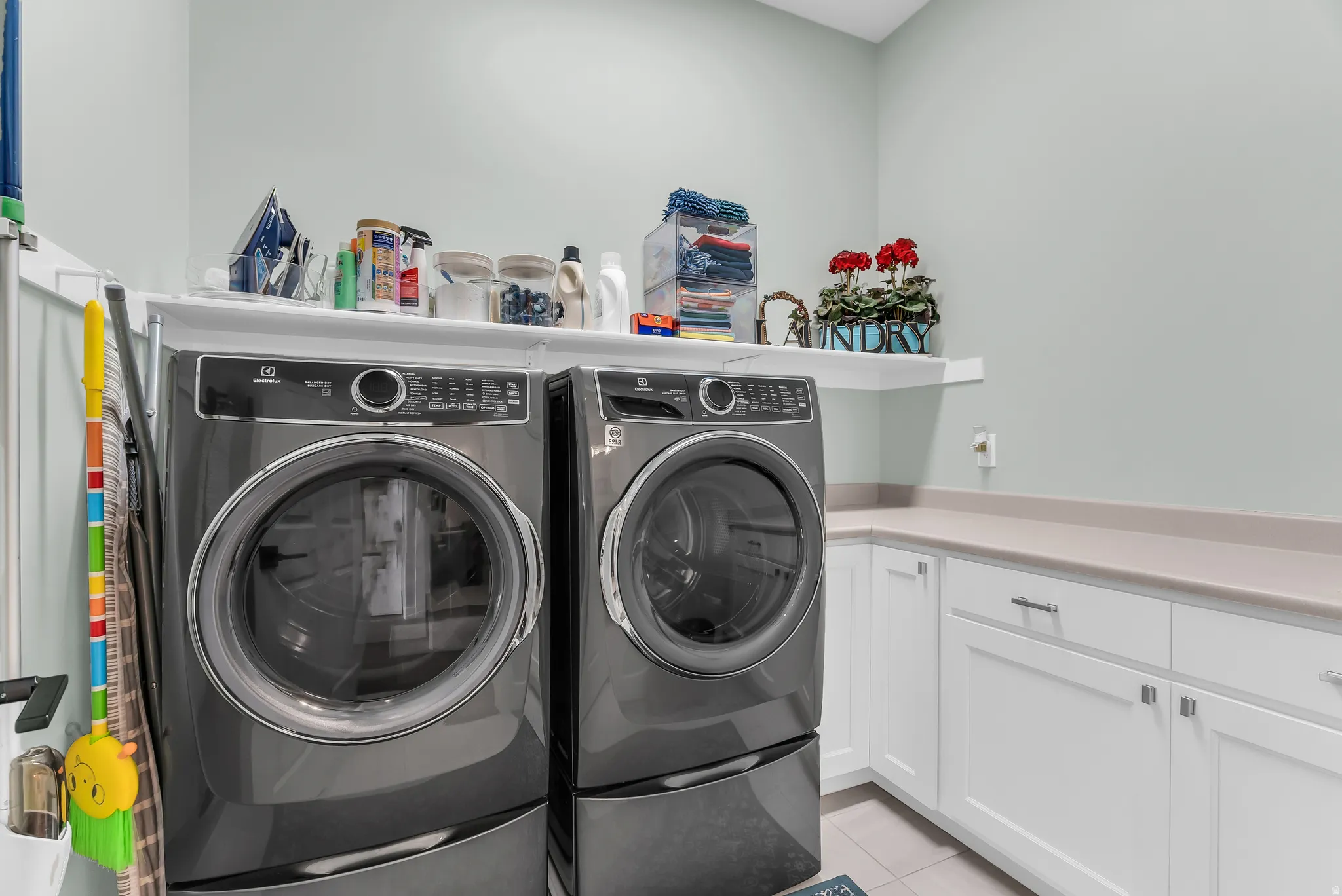 Built-in cabinetry with light-colored countertops, white shaker-style doors, and silver-tone hardware
