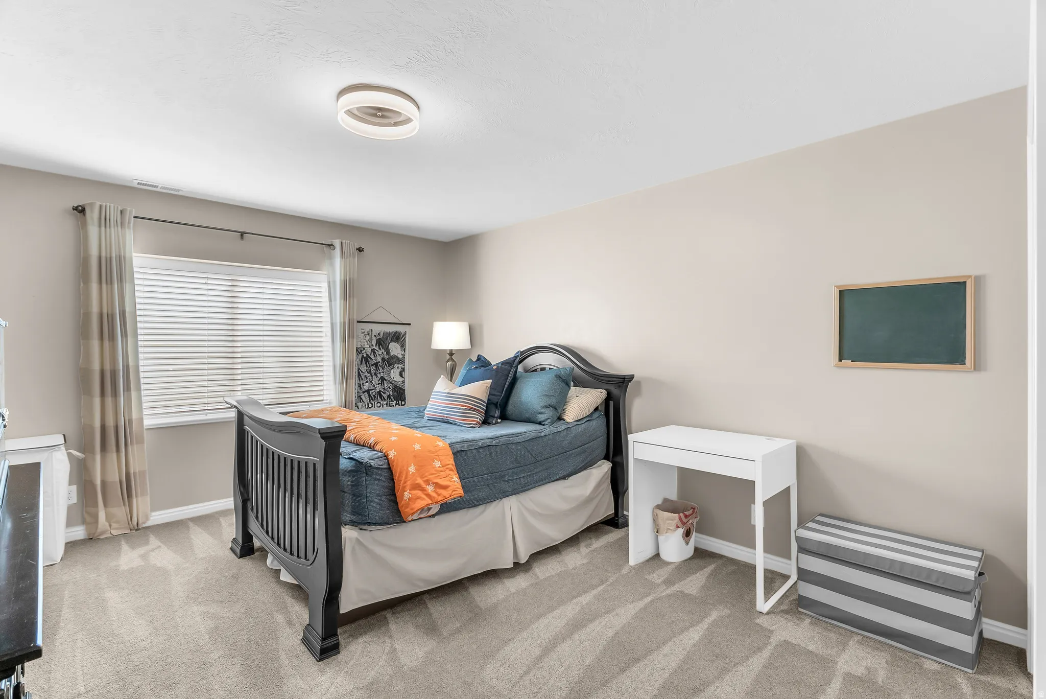Neutral paint tones complement the textured carpet flooring
