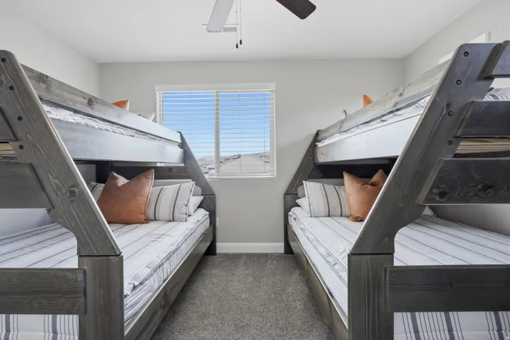 Wall-to-wall carpeting and a ceiling fan with light fixture