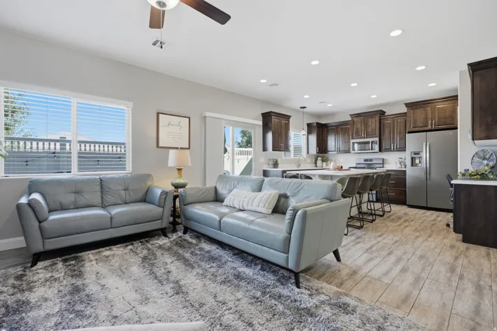 Open-concept living space featuring wood-finish flooring, recessed lighting, and a ceiling fan