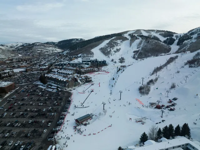 Aerial perspective showcasing a ski resort with multiple slopes and chairlifts