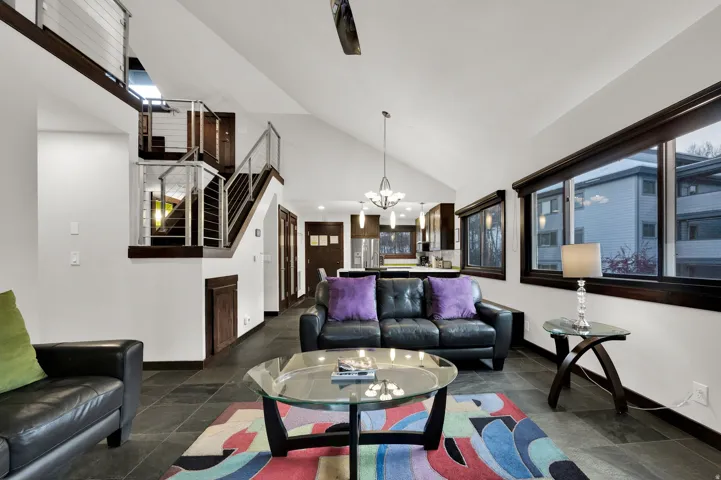 Vaulted ceiling with a contemporary chandelier and recessed lighting