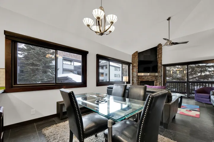Vaulted ceiling with an attached ceiling fan and pendant light fixture