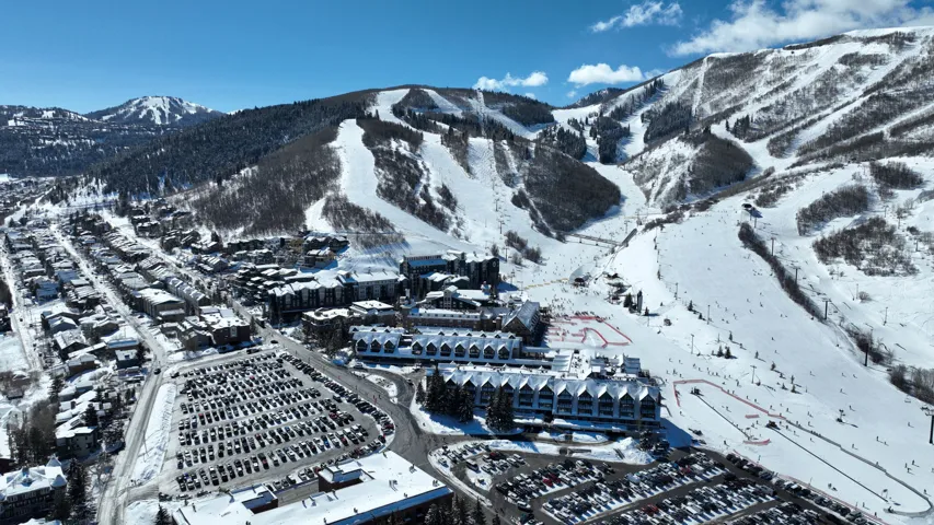 Expansive mountain ski resort setting with multiple slopes and chairlifts