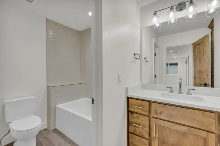 Light wood-finish vanity with an undermount sink and a light-toned countertop