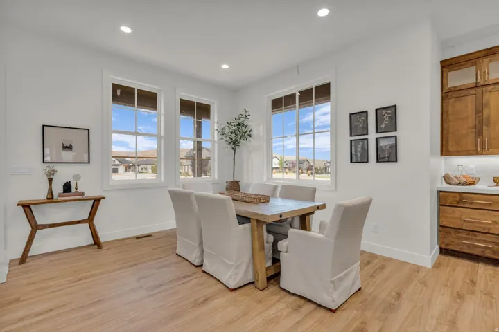 Recessed lighting, wood-finish flooring, white trim, and multiple large windows