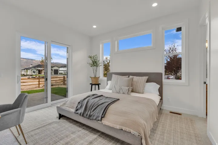 White walls and trim, recessed lighting, and large sliding glass doors