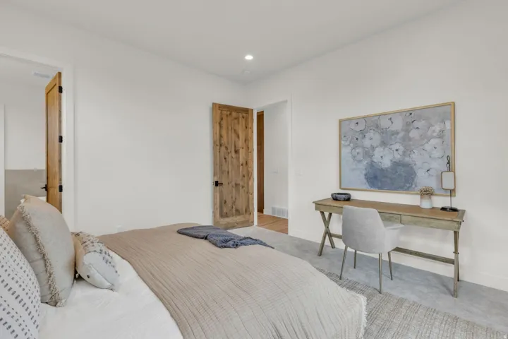 White walls with wood-finish doors and recessed lighting