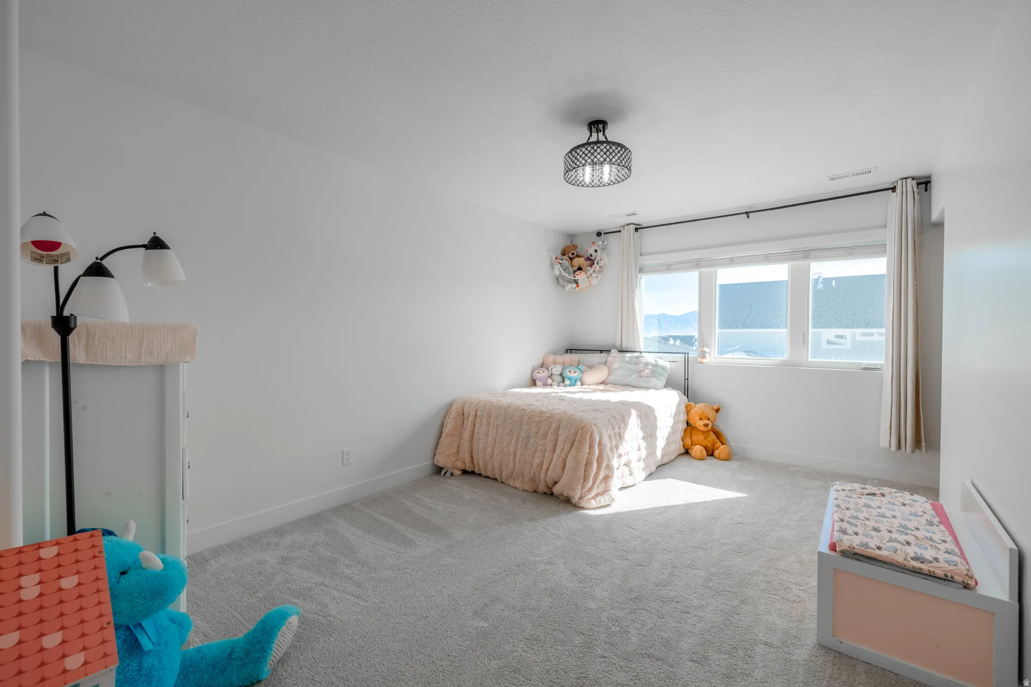 Bedroom 3~ White wall finishes, light grey carpeting, recessed window, dark metal ceiling light fixture, and white window blinds