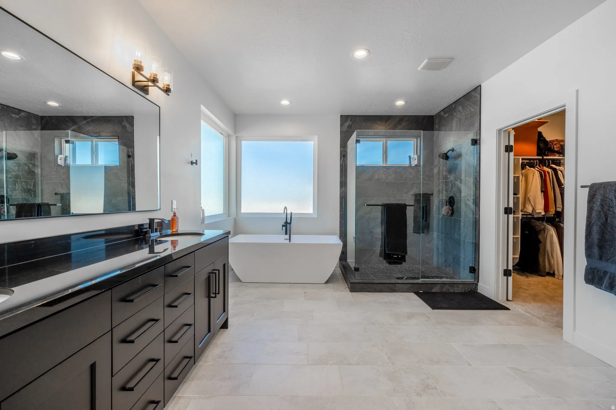 Dual vanity with dark cabinetry and countertop