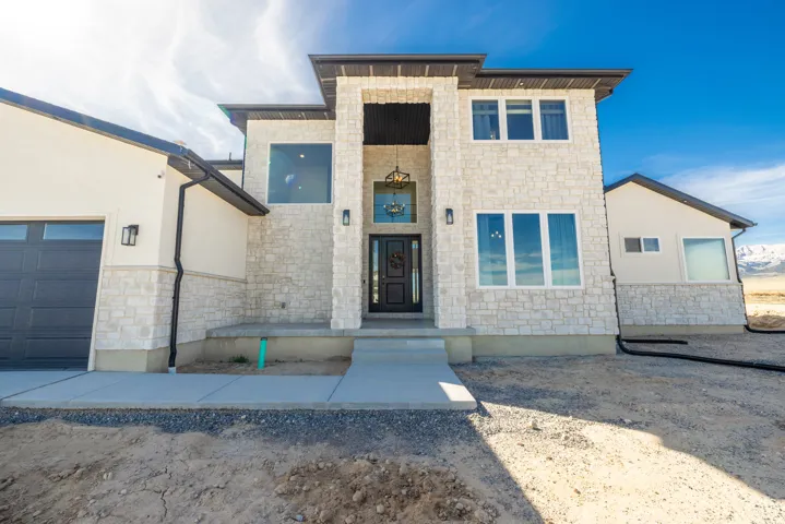 Modern exterior featuring a stone facade and stucco accents