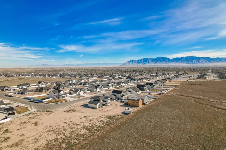 Expansive residential development featuring newly constructed homes and a mountainous backdrop