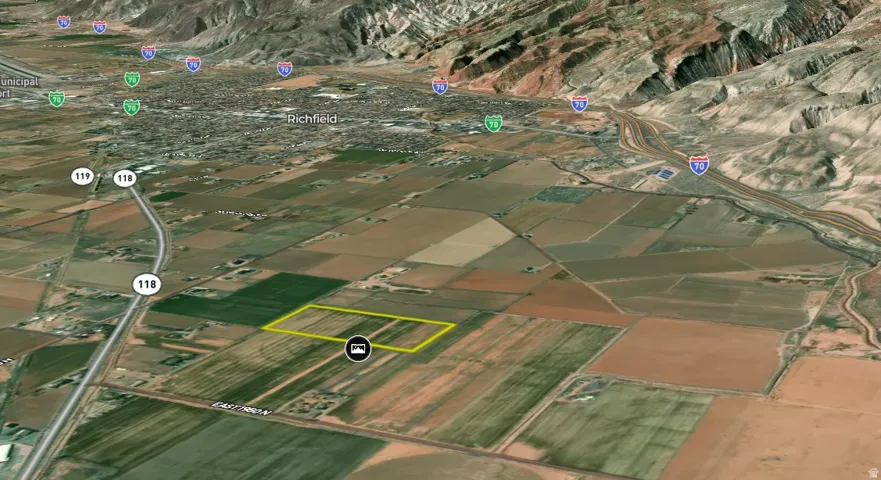 Aerial Map. Displaying a highlighted land parcel in relation to a municipality and roadways